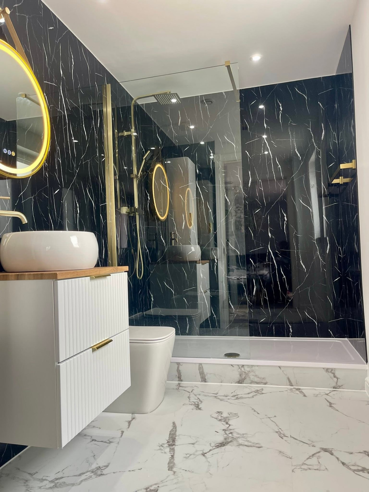 Black marble bathroom with gold fittings renovated in Glasgow